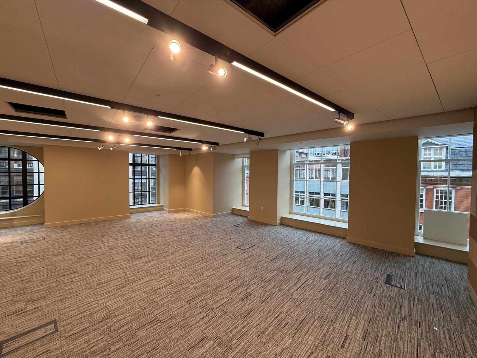 Freshly painted office suite in warm terracotta with feature lighting