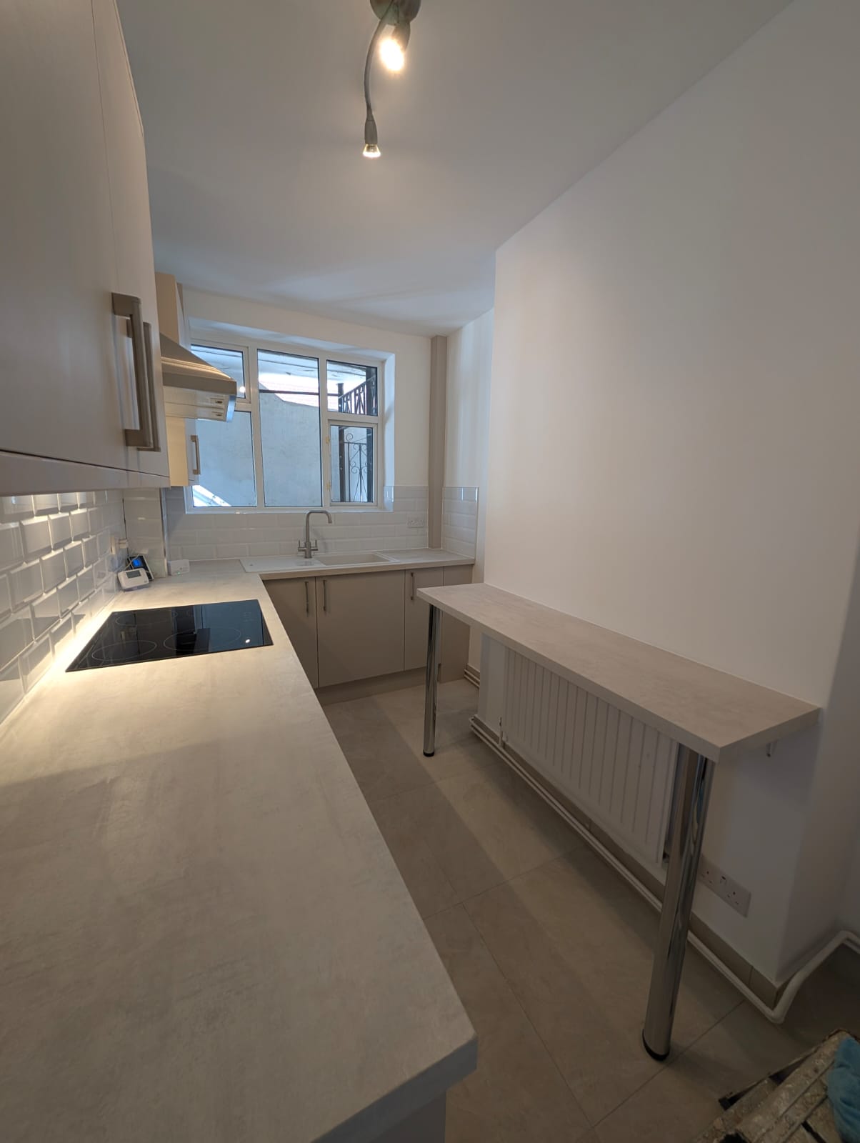 Newly fitted kitchen with warm under-cabinet lighting