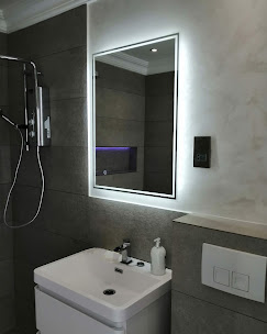 Tiled bathroom with backlit LED mirror