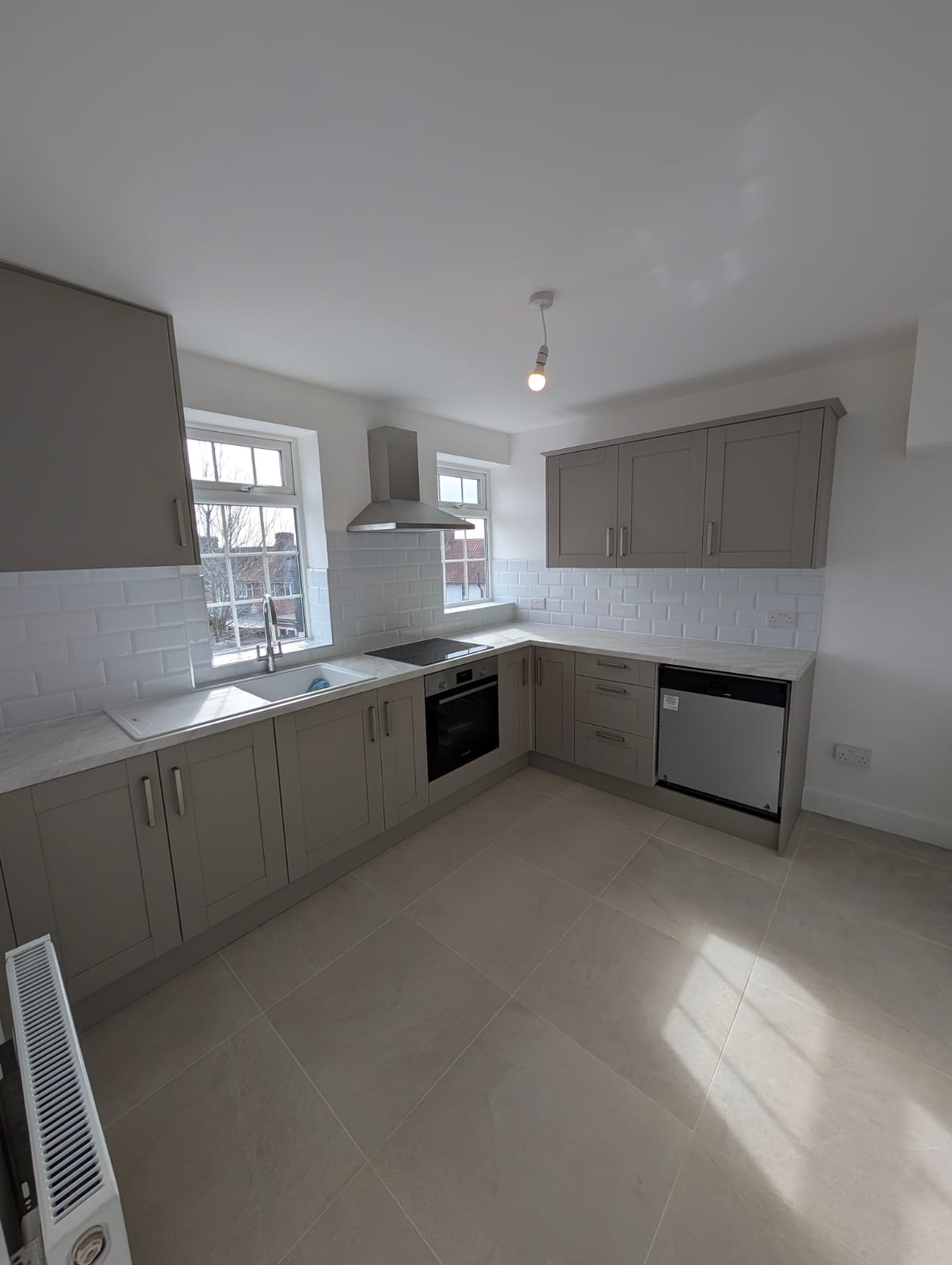 Grey shaker kitchen with marble-effect worktops