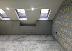 Loft conversion with fitted storage and skylights